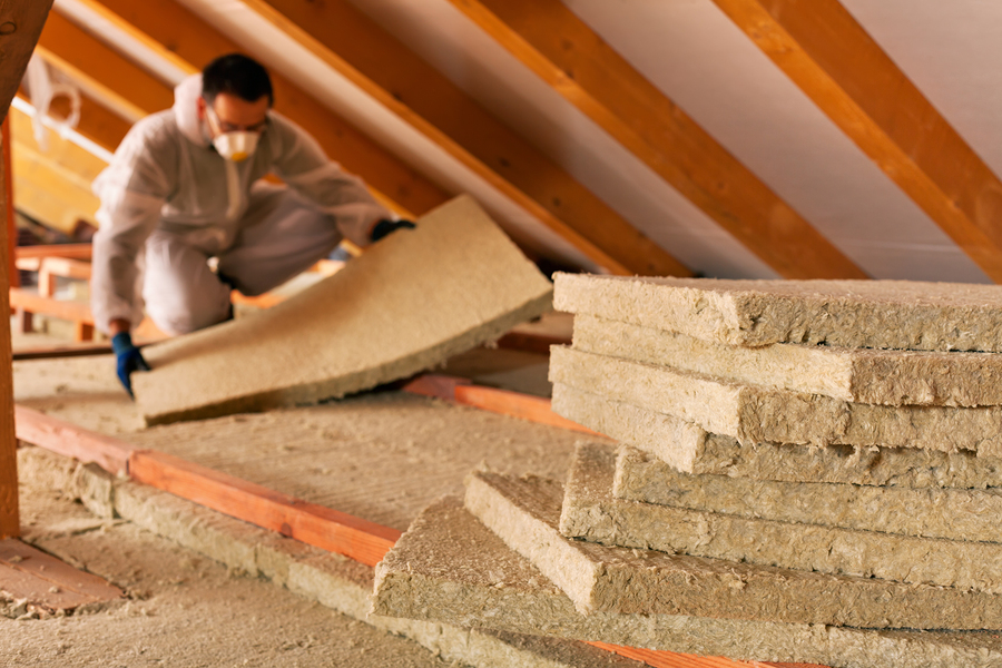 Man Laying Thermal Insulation Layer