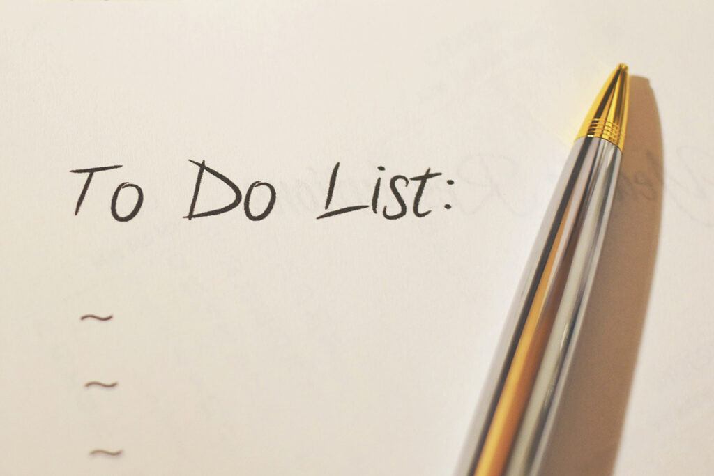 A pen sitting next to the words "To Do List"
