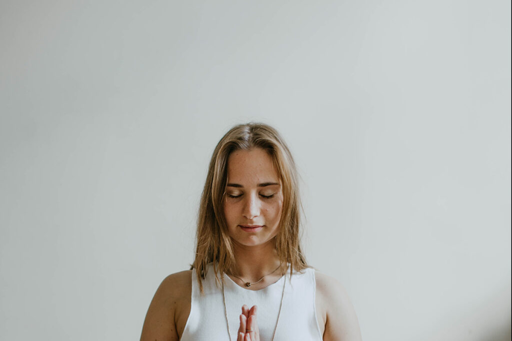 A woman with her head bowed in prayer